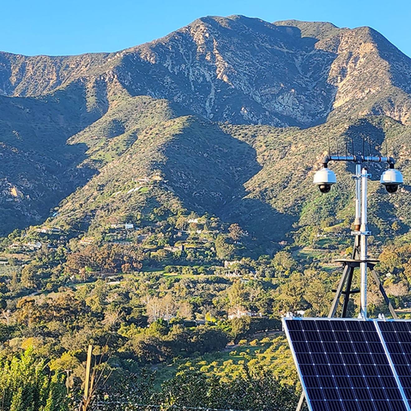 View of Ortega Ridge near Santa Barbara and cameras fitted with solar panels in the foreground