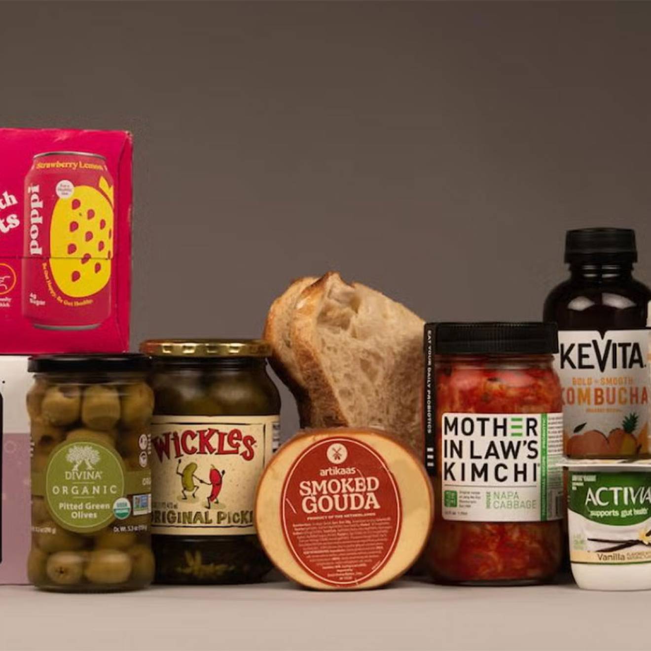 An arrangement of probiotic grocery products on a gray background