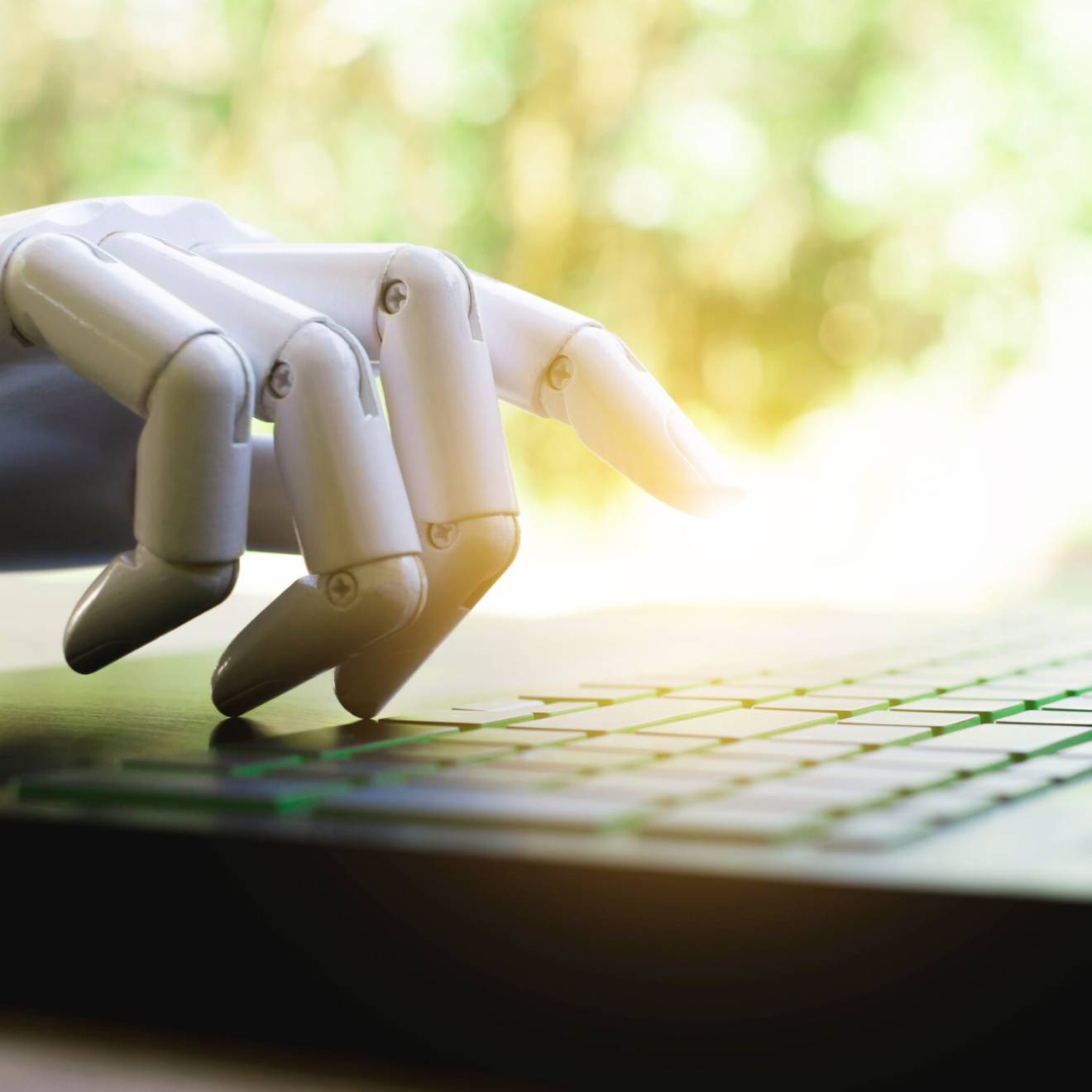 Robot hand on a computer in bright sunlight