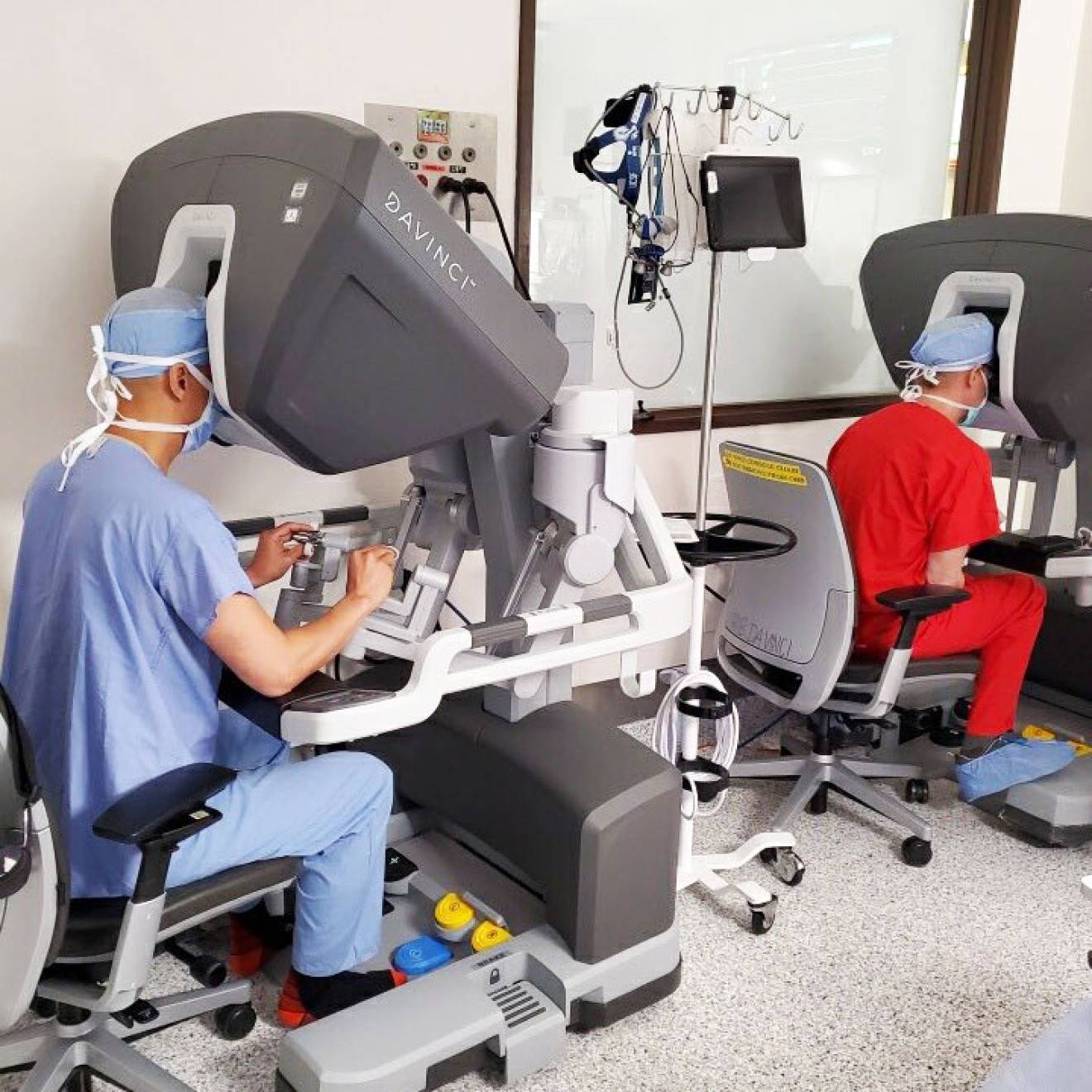 2 surgeons performing a cardiac surgery through machines