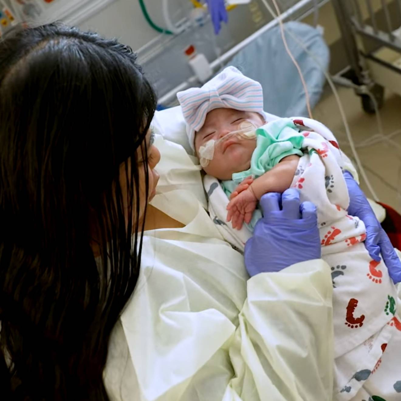 UC Davis Health saves baby A young woman holds a young baby in her lap at a hospital