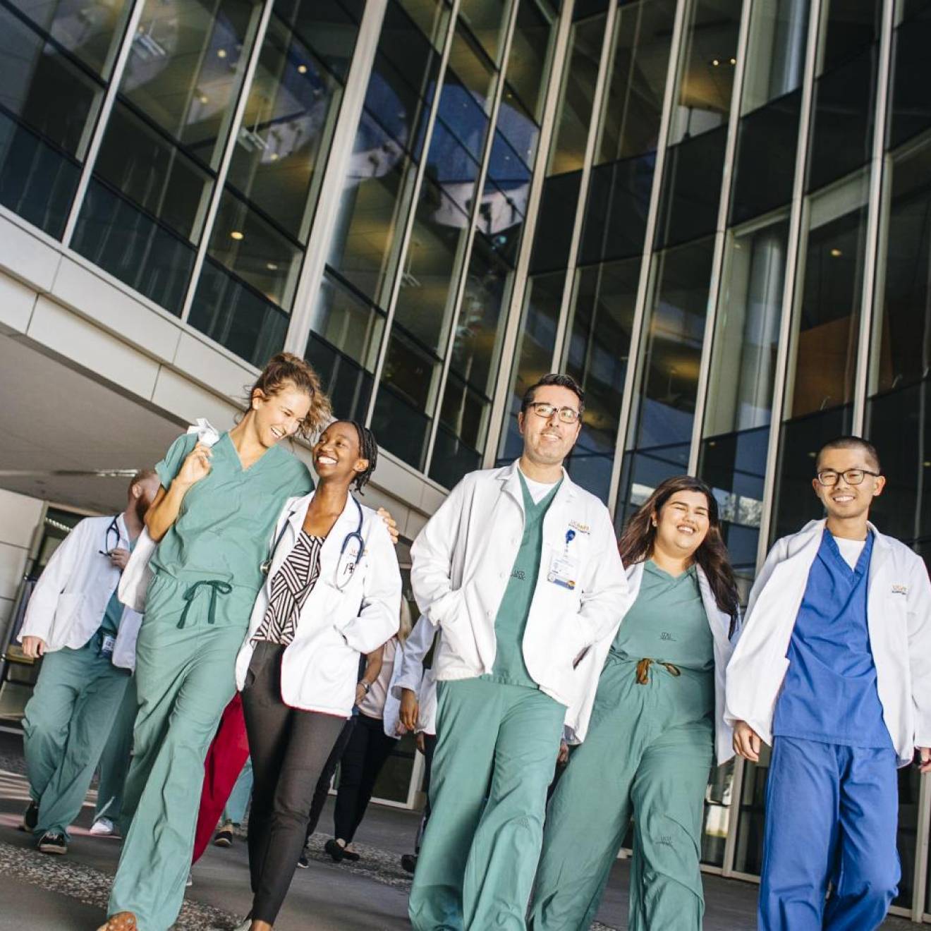 University of California Health students leaving a building together in scrubs