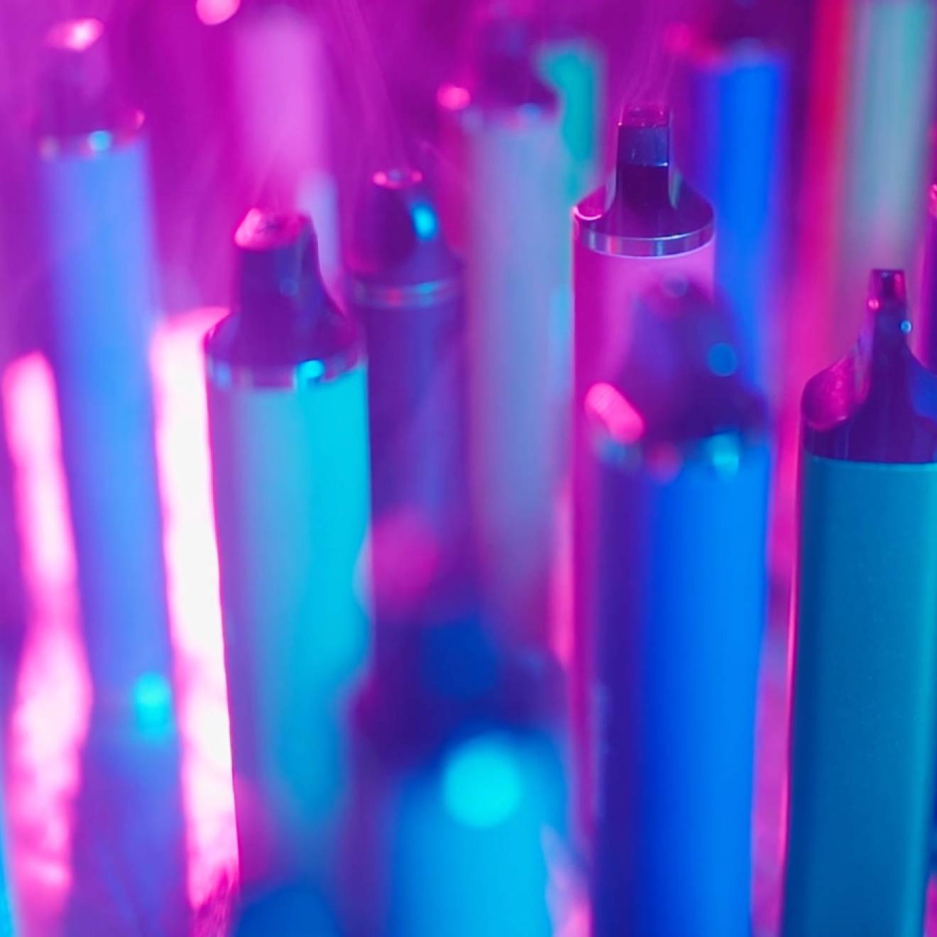 An array of vape pens in purple light